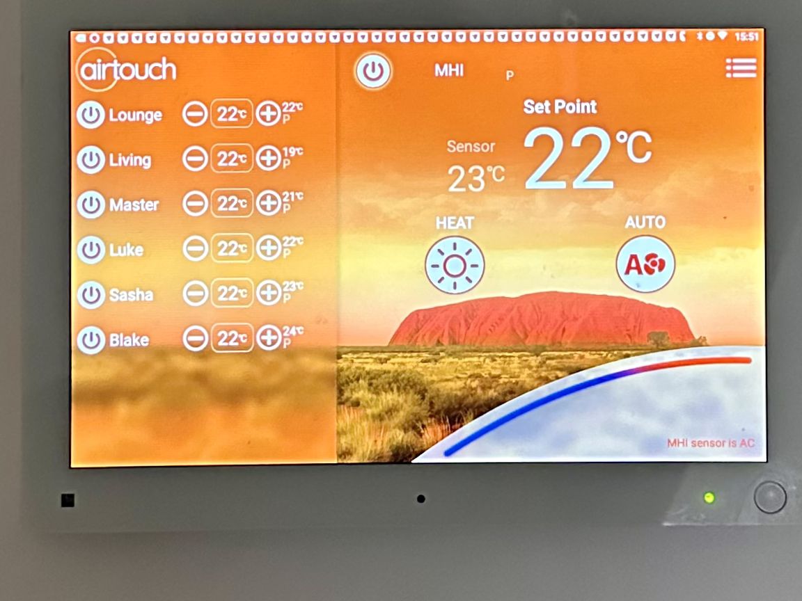 An AirTouch wall controller for a ducted heat pump system, showing six zones and a set point of 22 degrees